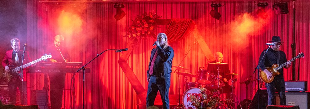Photo of the band playing on stage during the after party.
